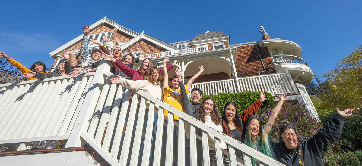 Occupational Therapy students and faculty posing on staircase in front of Meadowlands Hall