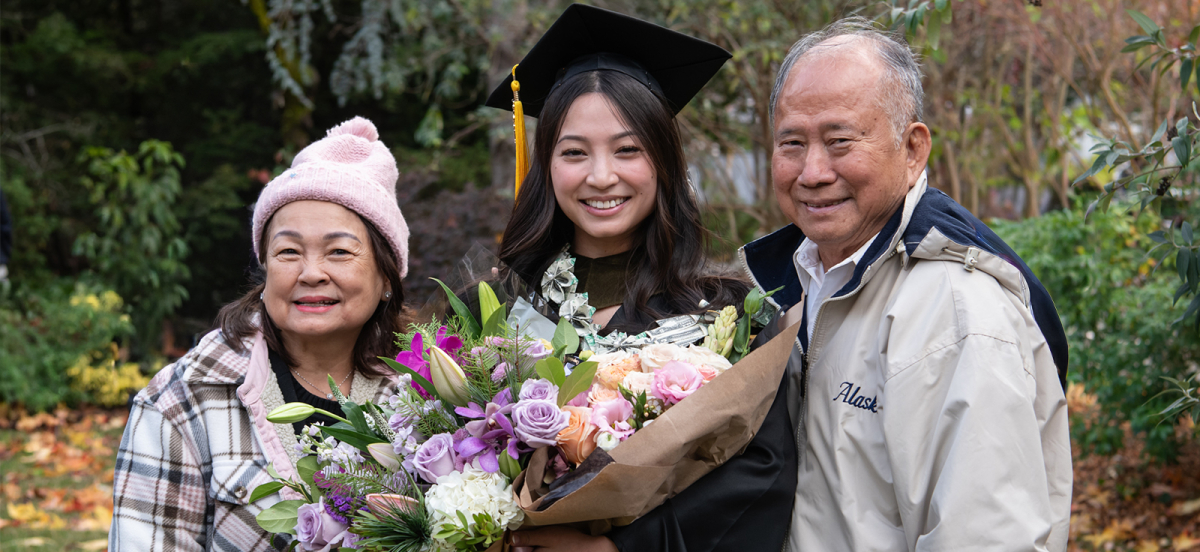 graduate holding a bouquet of flowers with grandparent