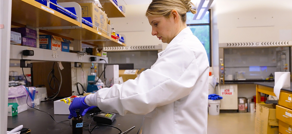 Student in biology lab with protective equipment
