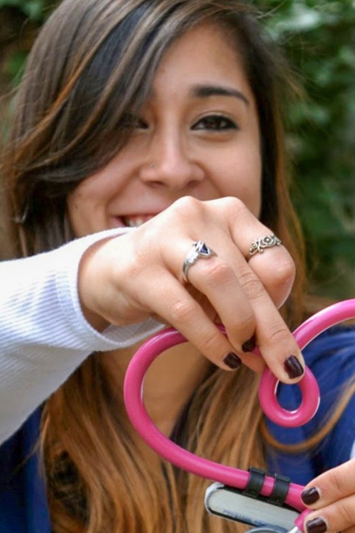Nursing student holding stethoscope in heart-shaped form