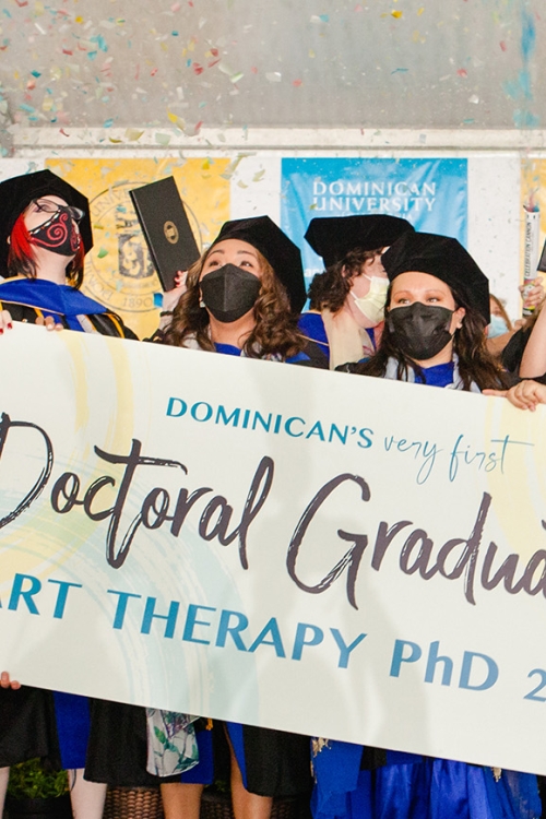 Art therapy PhD students walking during commencement
