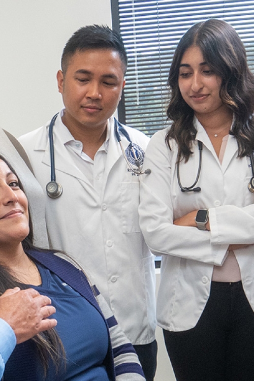 Students and professor learning to use stethoscope