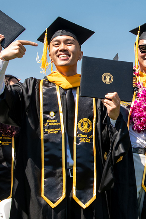 group of students at graduation ceremony celebrating