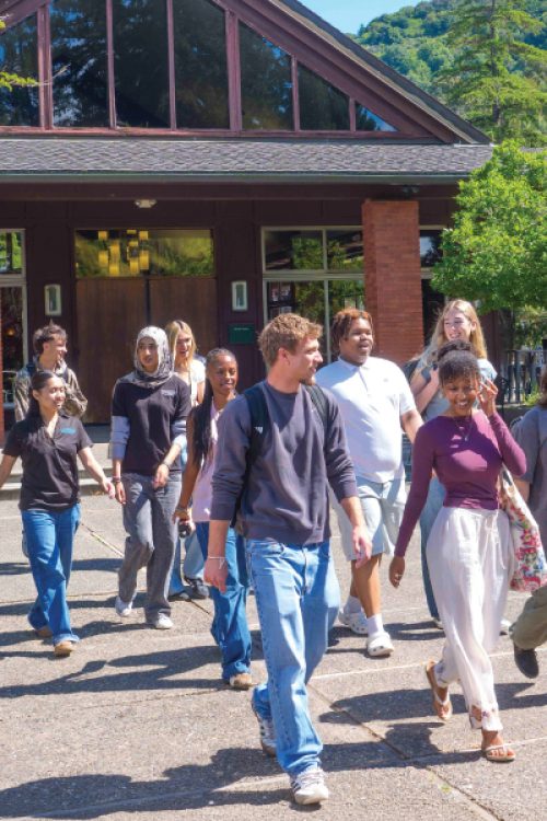 caleruega dining hall student group walking away. U.S. News and World report badge for 2026 and Money Best Colleges badge.