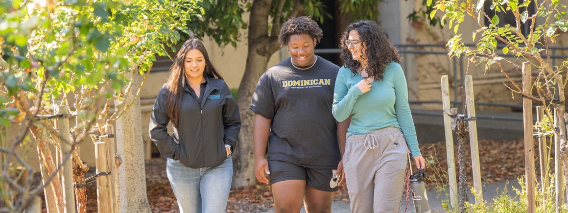 A group of students walking outside on the Dominican University of California campus.