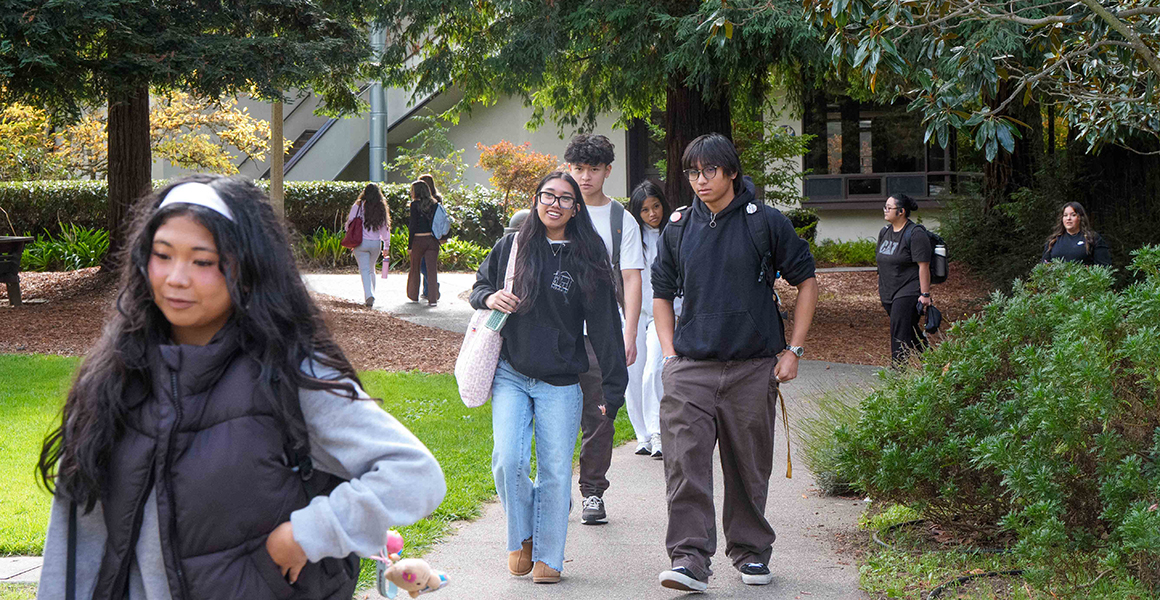 Students walking on a path on the Dominican University of California campus. 