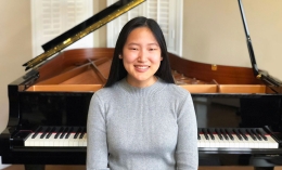 tia furness with piano behind her