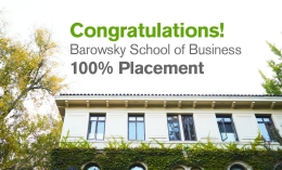 Image of top floor of Guzman Hall with graphic congratulating business school for 100% placement