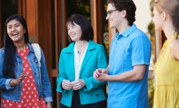image of Dominican President Mary Marcy talking with students in front of Alemany Library