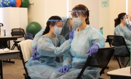 Occupational Therapy grad students doing lab work wearing PPE
