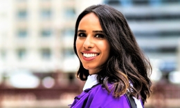 Dominican alumna Navi Dhaliwal in purple Northwestern University graduation gown