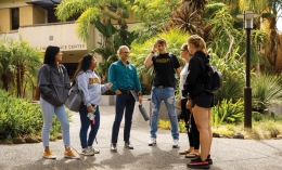 Assistant Professor of Psychology Dr. Ben Rosenberg talks to a group of students outside the Joseph Fink Science Center at Dominican University of California
