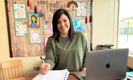 photo of Itta Gonzalez sitting at desk at Lynwood School for Teacher of Color Scholarship story