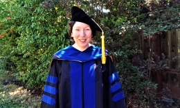 Photo of Dr. Dawn Fiacco posing in blue cap and gown at doctorate ceremony for Art Therapy program at Dominican commencement 2022