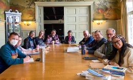 Students from Dominican's MFA program and program director Judy Halebsky seated at a table in the Hunt Room on the Dominican campus.