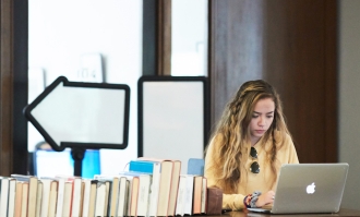 generic image of student in alemany library for duc mcoe news story