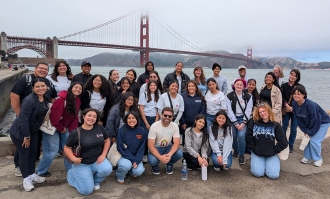 Students from the Avanza program pose in front of the Golden Gate Bridge. 
