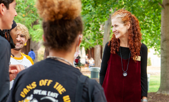 Dominican University of California President Nicola Pitchford interacting with students at a campus event.