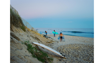 A photograph of surfers on a beach by Dominican alumnus Kenyon Anderson.