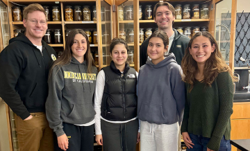 Dr. Tyler Johnson, associate professor in the Department of Natural Sciences and Mathematics, poses for the camera with some of his students.