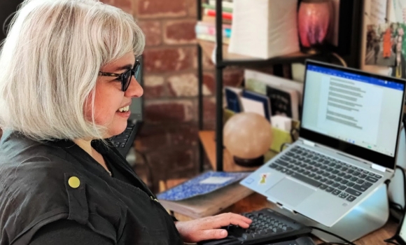 Photo of MFA in Creative Writing Student Andrea Clark Composing Poems At Her Computer