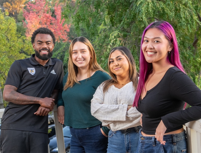 four undergraduate students smiling