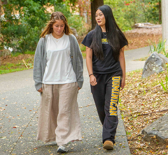 two female students walking down a path
