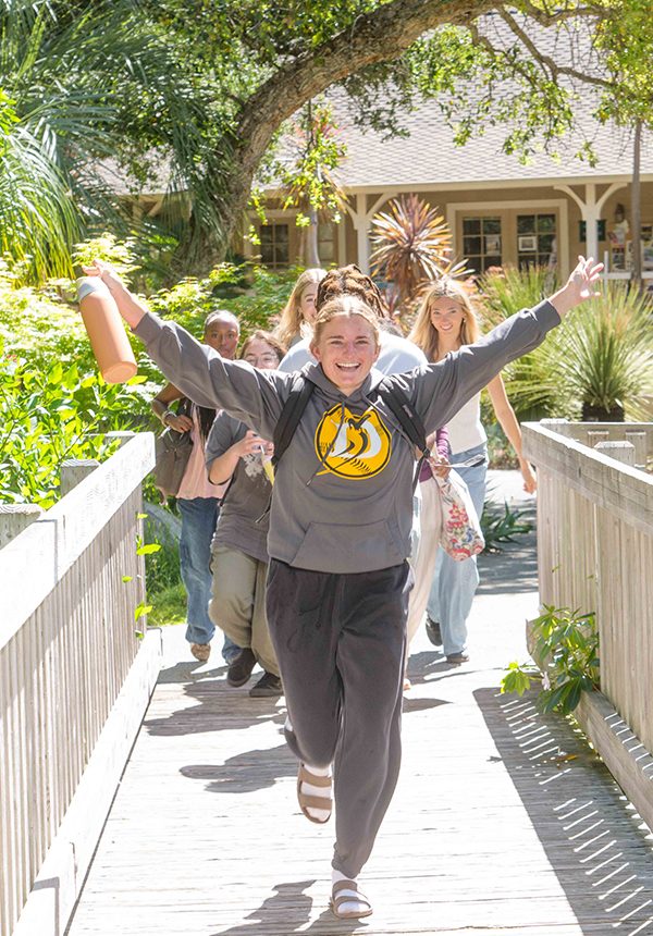 students walking down bridge