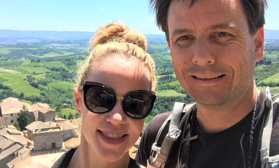 selfie of a couple with mountains in the background
