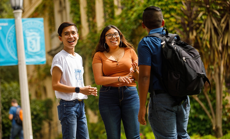 nhan pham chats with students on the dominican campus