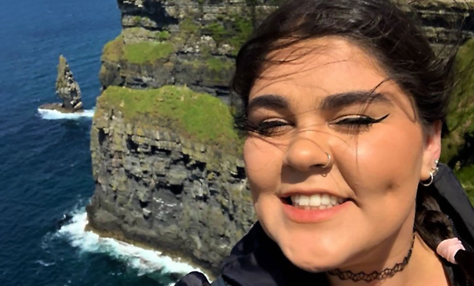 photo of OT student Julia Zasso above coast side cliff in Ireland