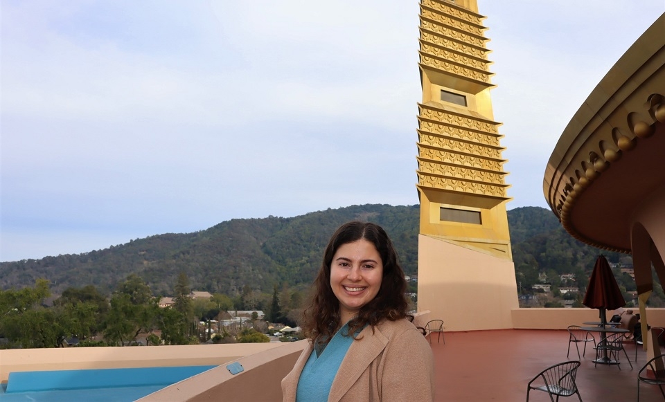 Photo of Julia Reinhard '22 smiling and posing for photo at Marin County Civic Center with spire in the background