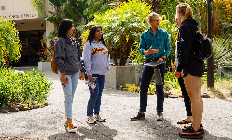 Professor Benjamin Rosenberg of Dominican's Psychology Department talks to students outside the Fink Science Center building on the Dominican campus.