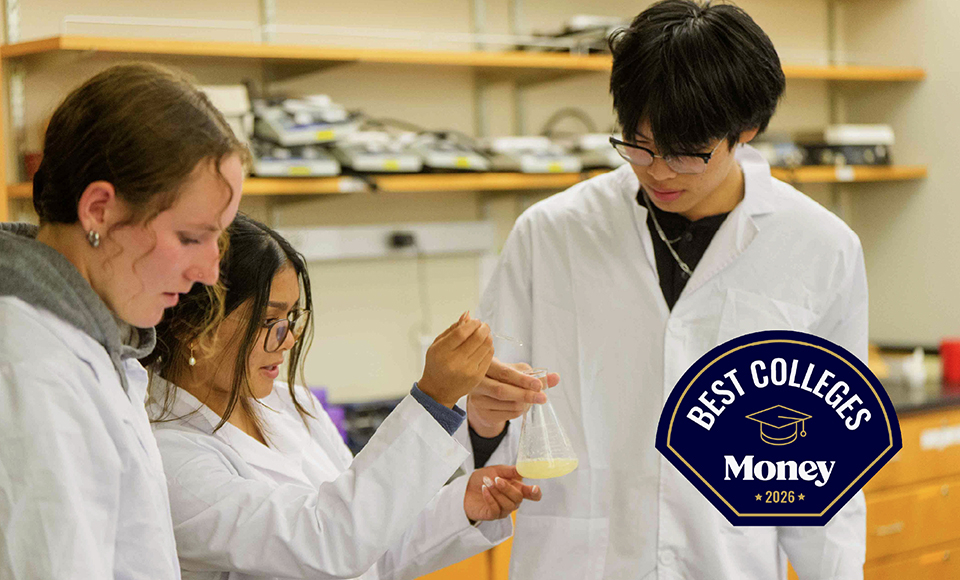 students in lab looking at a beaker with solution